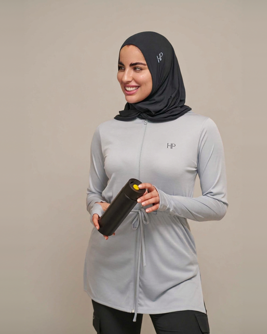 Light Grey – Mehreen lightweight zip hoodie jacket with waistband, styled with a hijab and water bottle