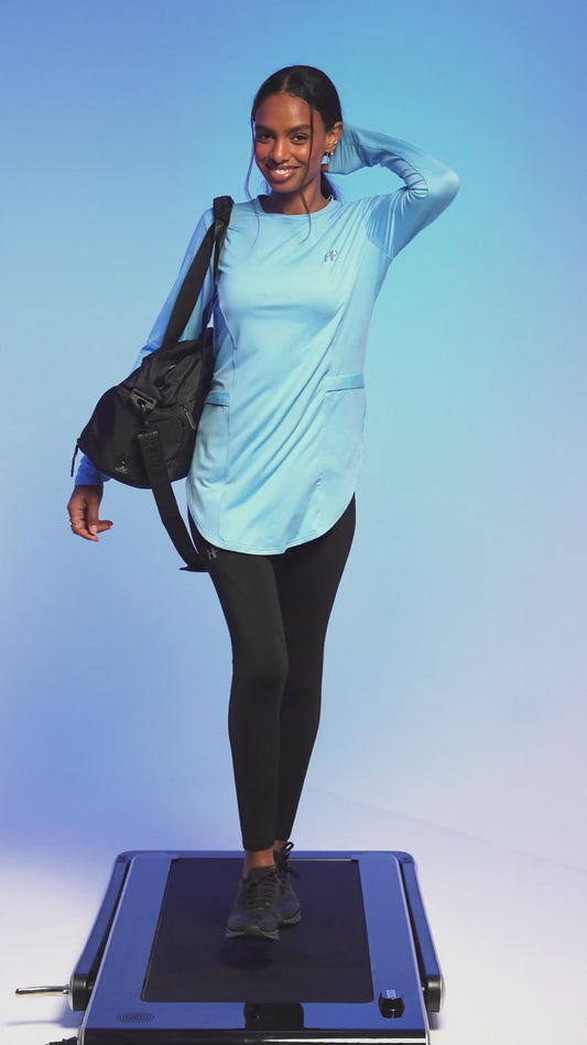 Light-blue long top turning on a platform, then a white shirt-style top with a Humble Power cap