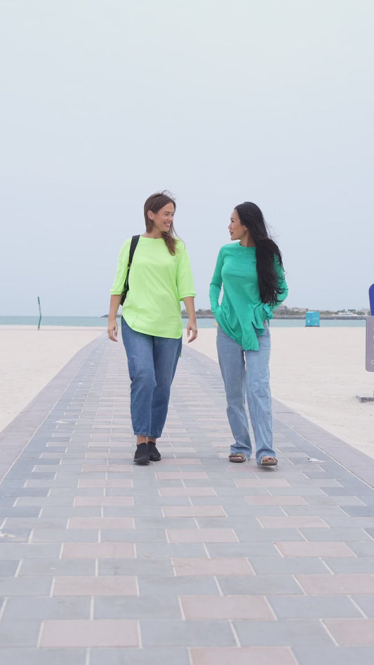 Friends on a beach day out in long modest tops and jeans