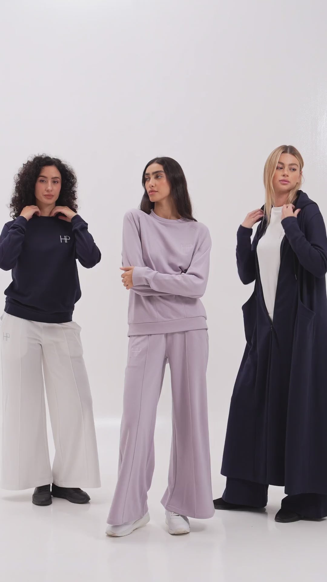 Three women in Humble Power French terry sets in lilac, navy and white