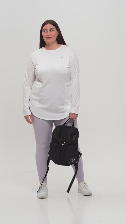 Plus-size model in a black zip jacket and leggings, carrying a Humble Power bag