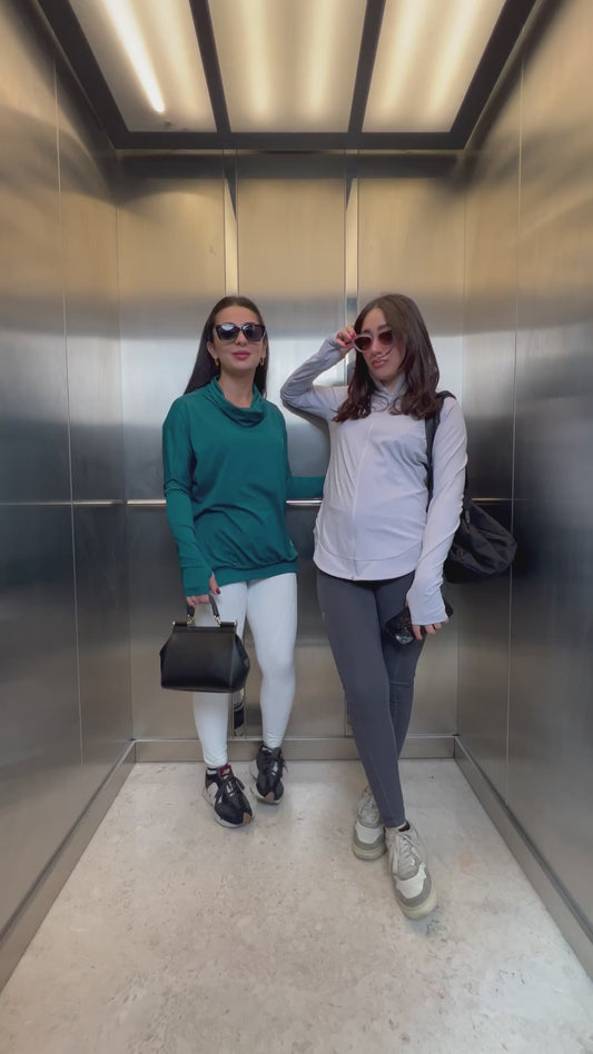 Two friends in a lift in a teal top and a light zip top, with the Humble Power gym bag