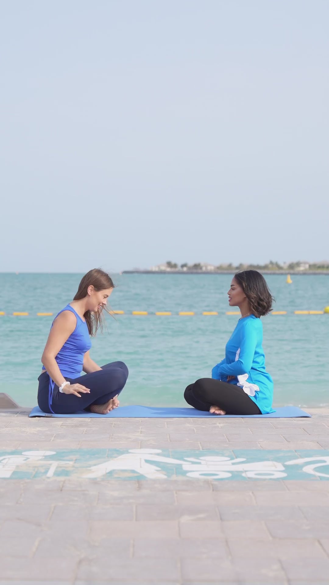 Yoga on the beach in modest tank tops and long tops